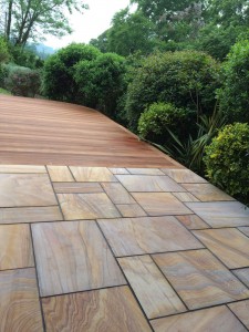 Hard wood decking and natural sandstone paving